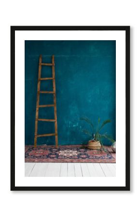 boho-style photo shoot area. dark, bright blue wall, plaster. carpet and wooden stairs