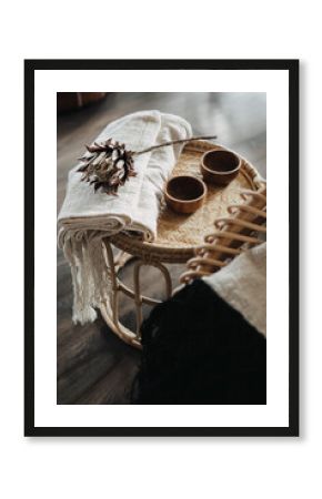 Coffee table with dry protea flower and wooden cups