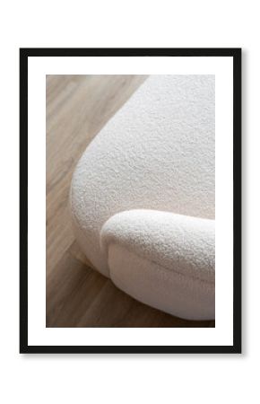 Couch armrest with white plush fabric and textured surface