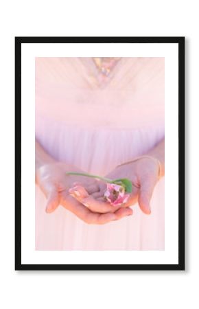 woman in pink dress holding alstroemeria flower
