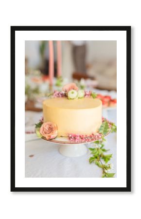 Wedding cake with flowers, boho style table setting. Holiday cake on table