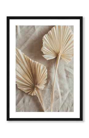 Tan fan craft leaves on beige washed linen cloth. Flat lay, top view.