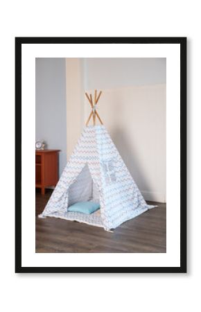 Children's hut with toys in the room. Interior of the children's room with tent-hut for children's games in boho style, bright interior of the children's room with a wigwam.Scandinavian style