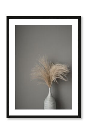 Beige reeds, pampas grass against grey wall. Beautiful interior concept with neutral colors. Aesthetic minimal, stylish, trend concept. Parisian vibes