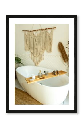 Stylish bathroom interior in boho style. The bathroom has a shelf for brushes, soap and body oils.