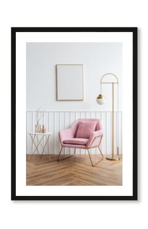 Blank picture frame by a pink velvet armchair