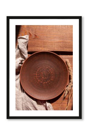 Empty craft handmade clay plate and pampas grass wooden background. Table place hand crafted dish Natural cottagecore styled tableware minimal home interior decor Restaurant food countryside aesthetic