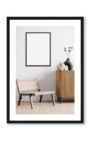 Blank picture frame mockup on a white wall. Portrait orientation. Artwork template mock up in interior design. View of modern boho style interior with chair