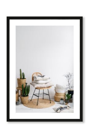 chair, decorative pillows and plants in apartment with bohemian style