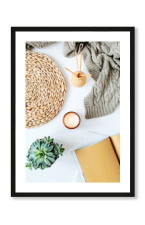 Boho style modern minimal home workspace desk with notebook, succulent, knitted plaid, candle, aroma sticks, straw wicker napkins on white background. Flat lay, top view bohemian lifestyle blog.