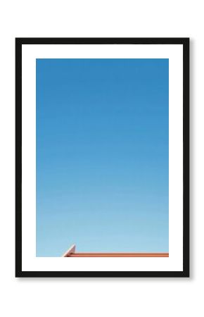 Minimalist architectural detail showcasing vibrant orange metal structure against a serene gradient blue sky, capturing geometric simplicity and clean design aesthetic