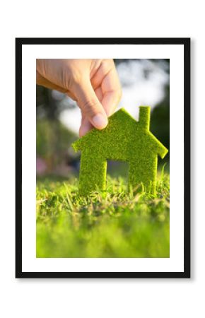 Eco house concept ,hand holding eco house icon in nature
