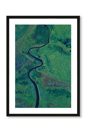 Aerial view of river winding along green landscape of Krabbe Peninsula