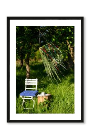 Grass crown and chair in summer garden Altes Land Hamburg Germany