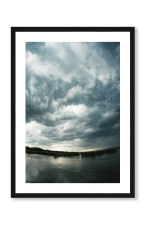 Storm clouds over the lake at sunset