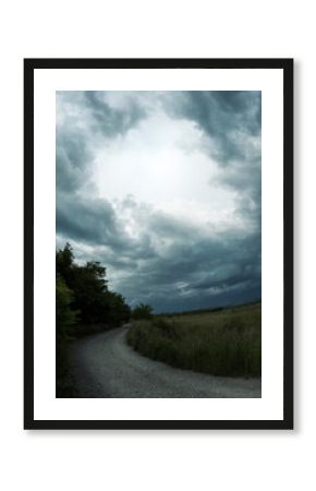 Storm clouds over winding road 