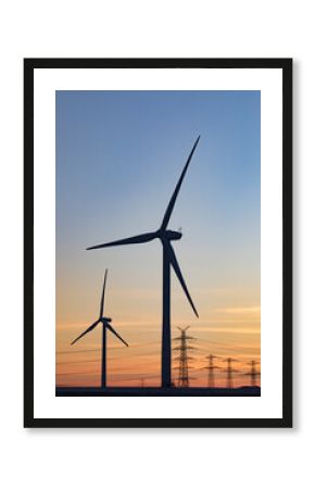 Germany, North Rhine Westphalia, Niederaussem, Wind turbines at sunset