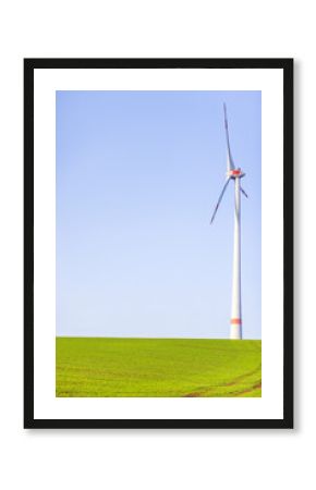 Wind turbine standing against clear blue sky