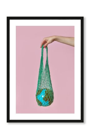 Woman holding globe in crochet bag