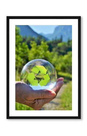 hand with crystal sphere with recycling code symbol