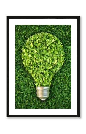 Light bulb crafted from green leaves symbolizes eco-friendly energy solutions surrounded by grass