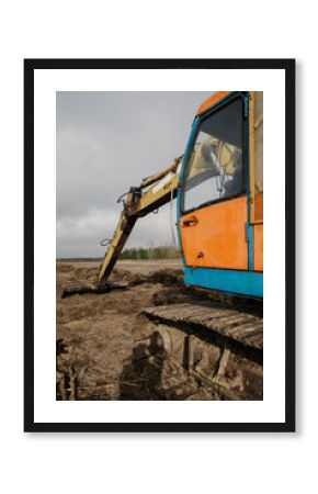 The excavator is leveling the ground.