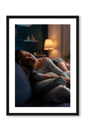 Depressed sad man and woman laying on couch in despair, suffering from chronic depression and mental health difficulties. Desperate anxious partners having suicidal thoughts and pain.