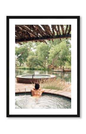 Woman relaxing in swimming pool in spa resort