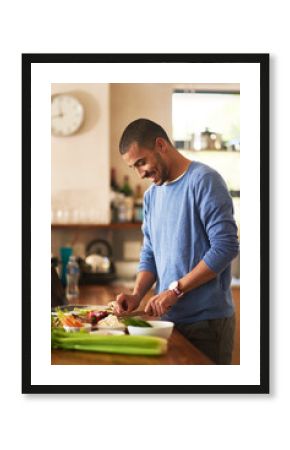 Making a healthy meal from scratch. Shot of a happy young man preparing a healthy snack at home.