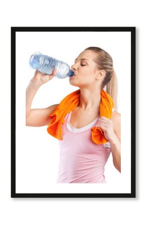 Young woman drinking water after work out