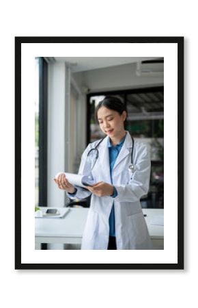 An attractive young Asian female doctor is checking medical cases on a clipboard.