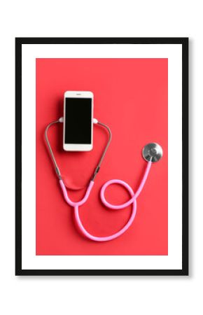 Stethoscope and mobile phone on red background