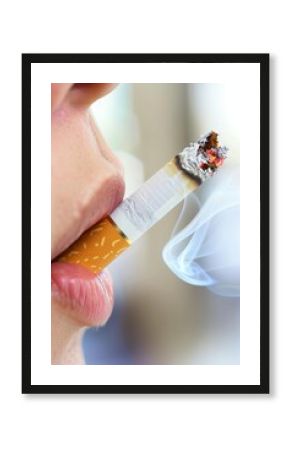 Close up of young man smoking cigarette, emphasizing detrimental impact on health risks