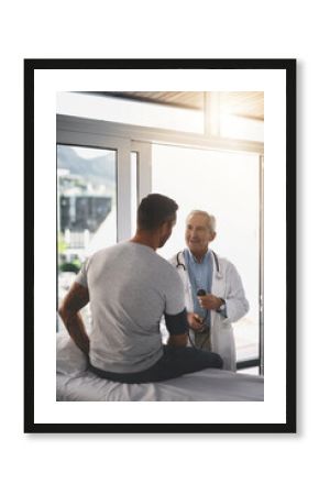 Smile, man and healthcare doctor with blood pressure test, checkup and assessment in clinic. Advice, patient and medical professional in consultation for hypertension, diabetes or health insurance