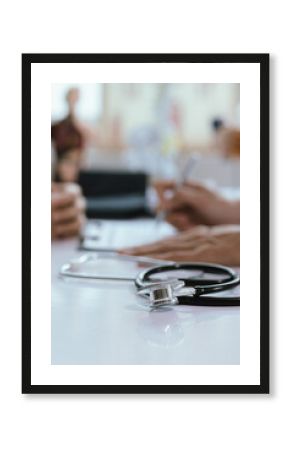 Asian male doctor consults with patient in clinic, reviews medical documents and uses stethoscope to diagnose health conditions, and confidently provides professional advice and care.