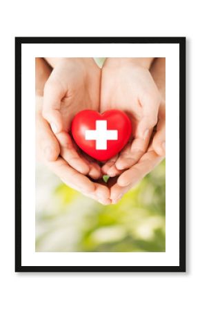 male and female hands with red heart