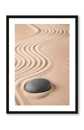 Zen background with stone and pattern of lines in the sand. Focus on concentration and spirituality for harmony and purity. Spa wellness therapy or yoga theme...