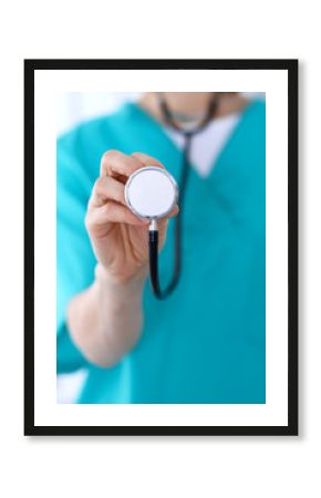 Female doctor holds stethoscope head closeup. Physicians ready to examine and help patient. Medical help and insurance in health care, best treatment and medicine concept