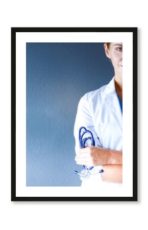 Portrait of young woman doctor with white coat standing in hospital.