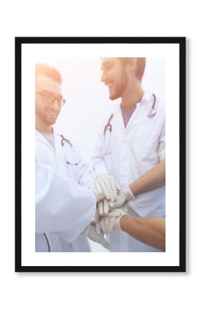 group of doctors,clasped their hands together