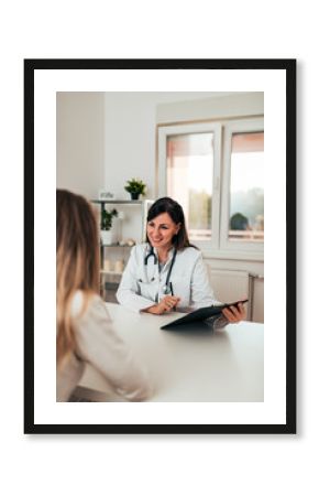 Female doctor and female patient talking about test results.