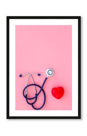 Heart health, health care concept. Stethoscope near rubber heart on pink background top view space for text