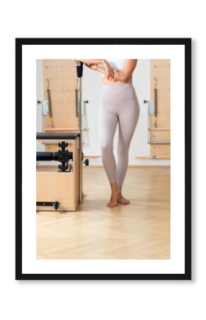 Unrecognisable sportswoman standing at pilates studio.