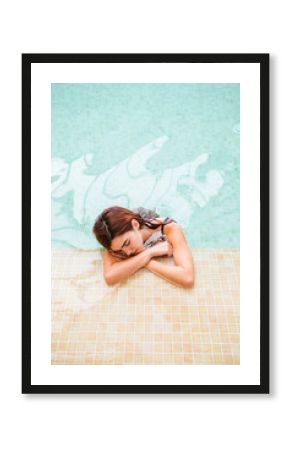 Young woman relaxing in swimming pool of a spa