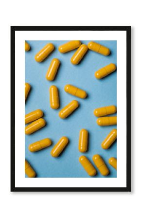 Yellow capsules on blue background