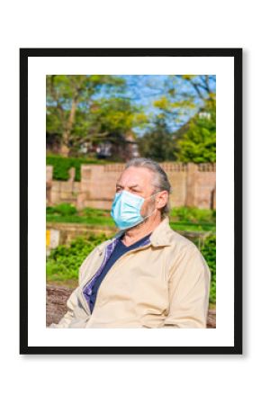 Portrait of a middle aged male wearing protective face mask whilst outdoors