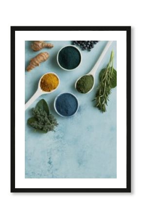 Functional powdered ingredients with spirulina, turmeric, and green tea on kitchen countertop for modern wellness and integrative nutrition promotion