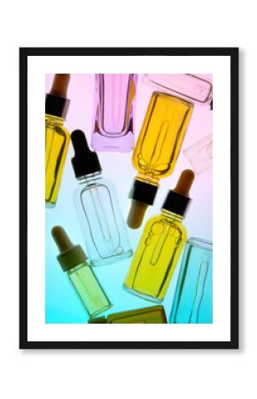 Many Colorful Cosmetic Bottles With Droppers on a Vibrant Background