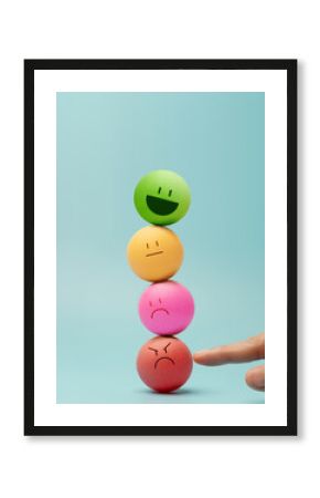 Hand balancing Colorful emotional faces Ball, symbolizing mental health and emotional