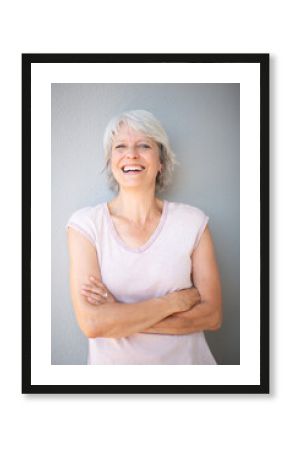 Woman with arms crossed smiling at camera